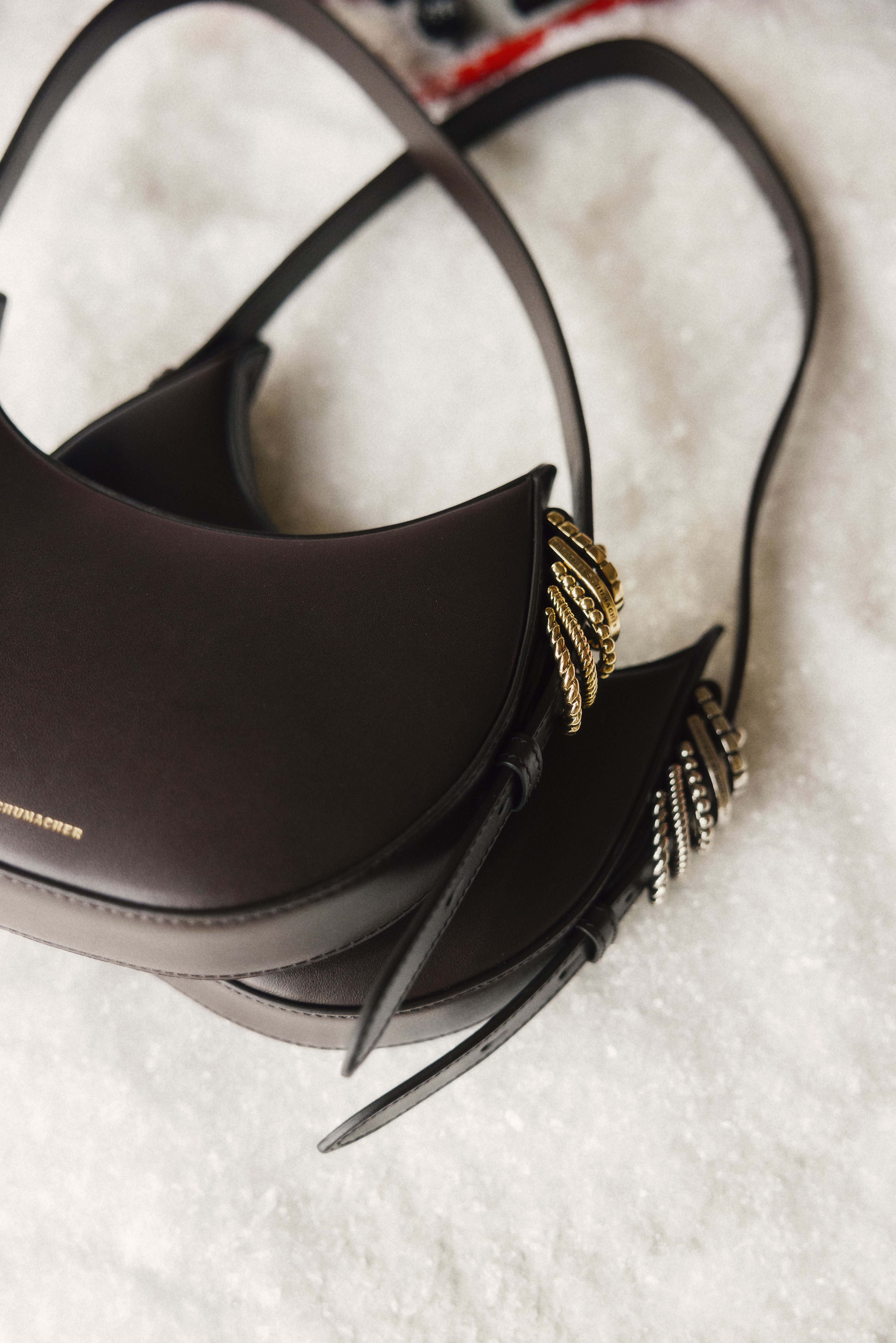 two mini leather bags on snow