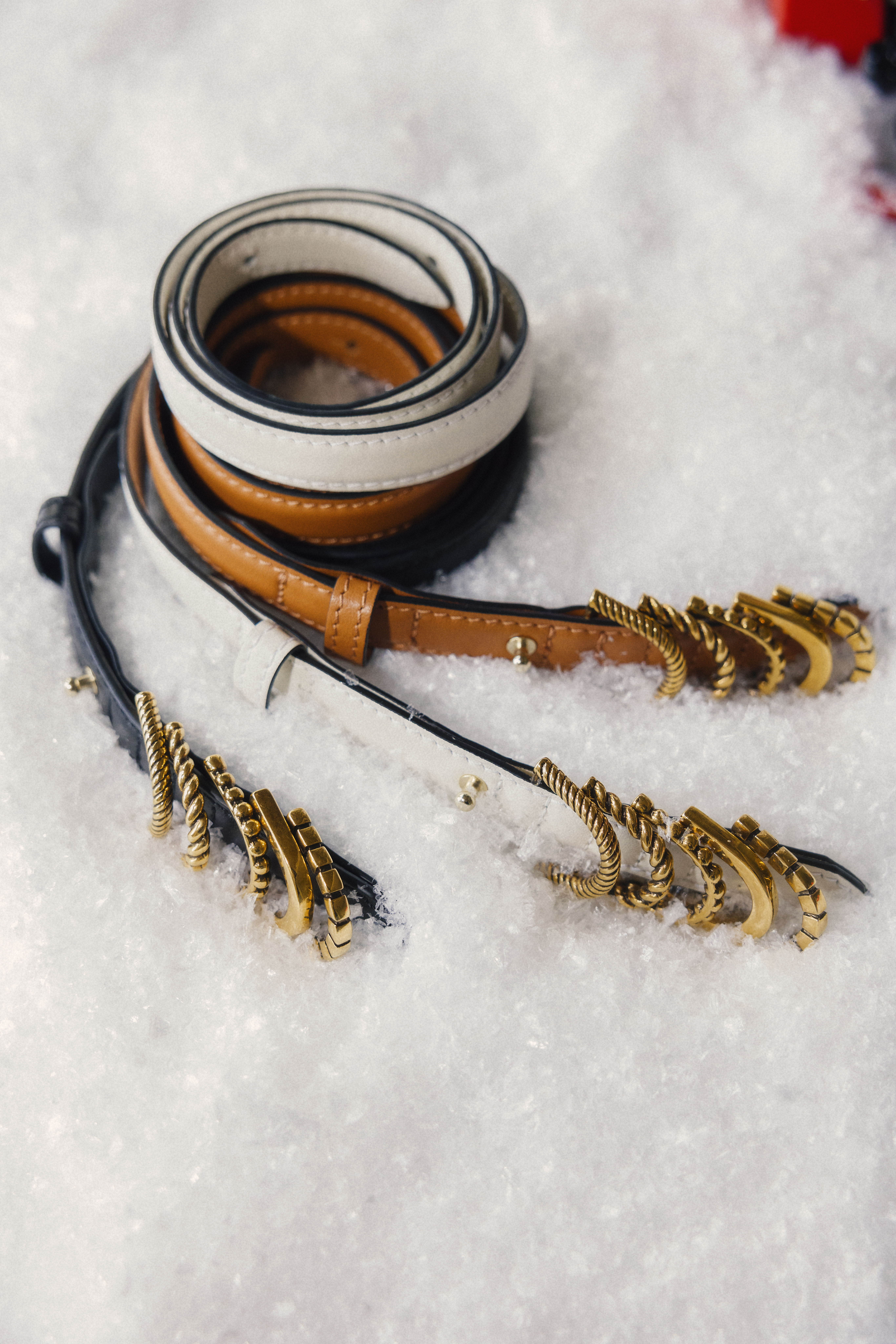 three lether belts on snow