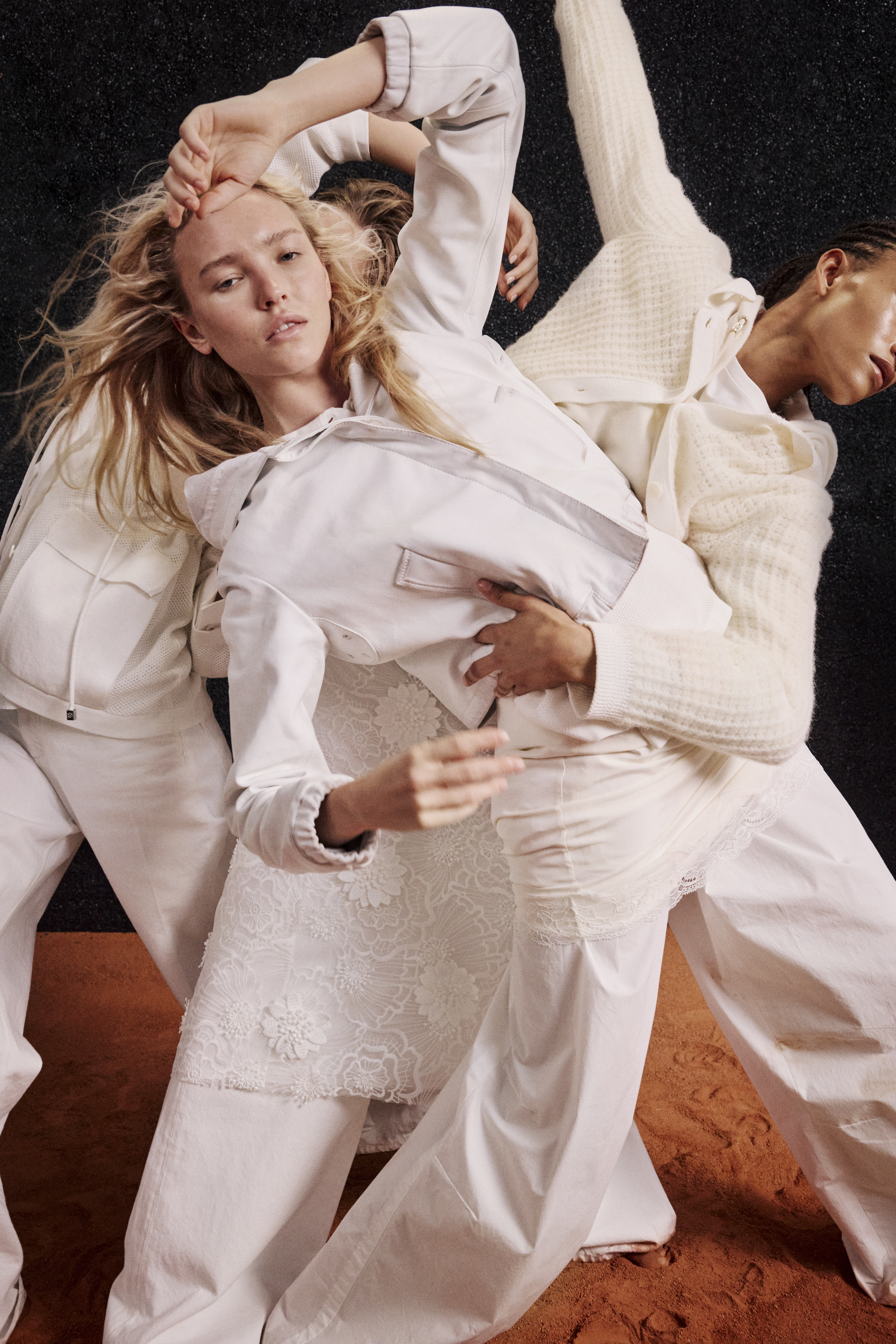 three women wearing white clothes and dancing in it together