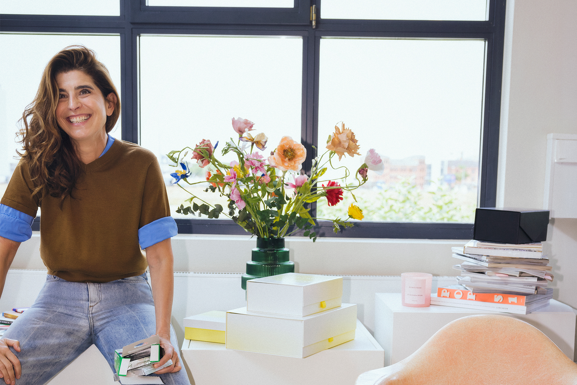 Dorothee Schumacher wearing a top and a denim from her own Fall Winter Collection while being in her office