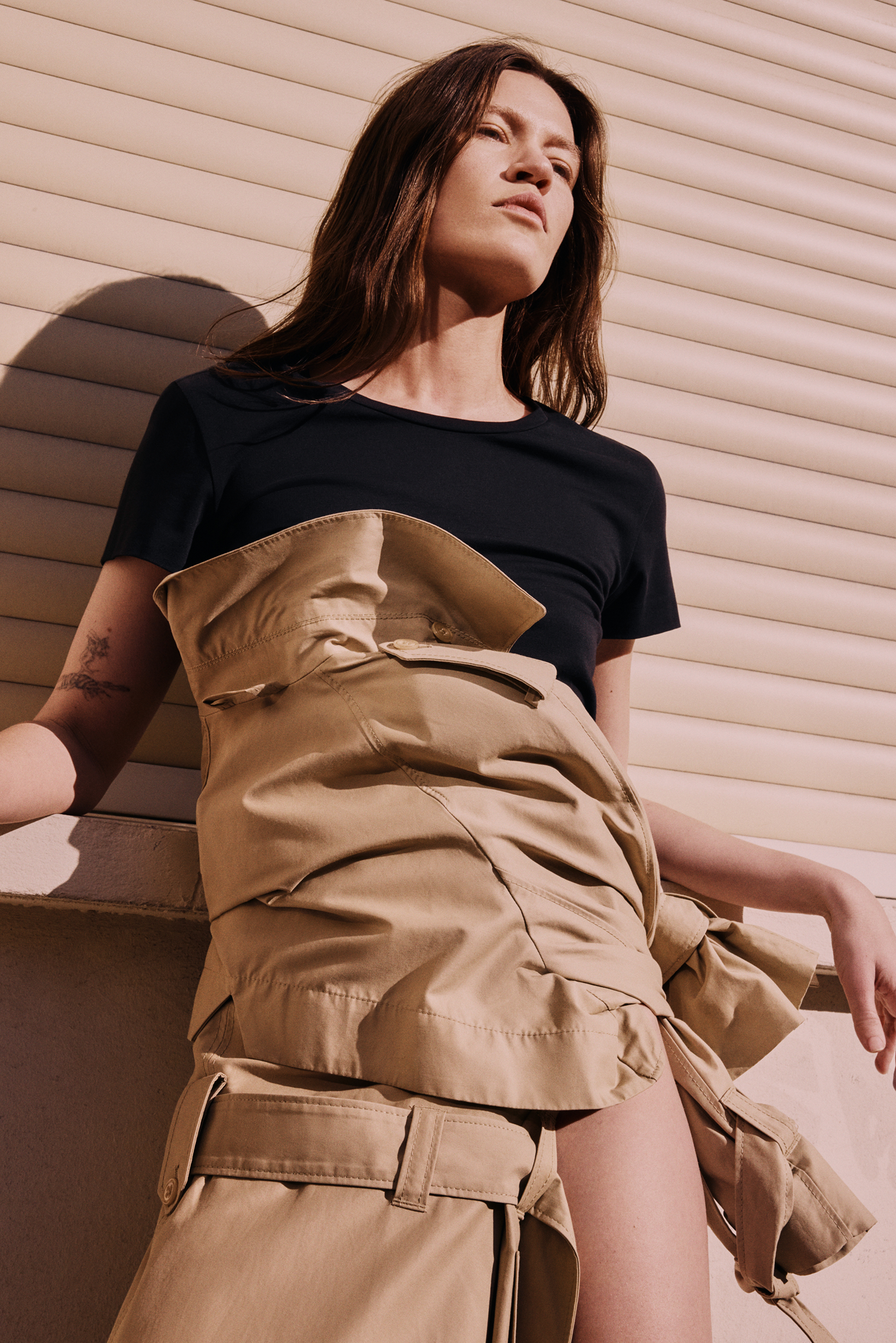 Model with trenchcoat and black top