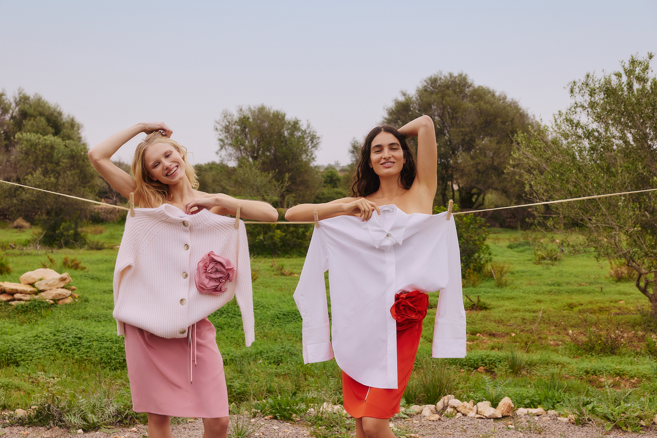 two girls outside in garden smiling