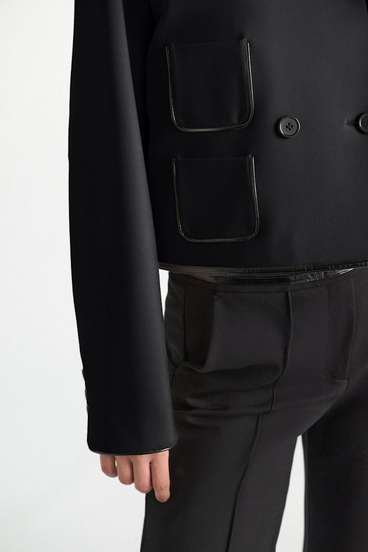 Dorothee Schumacher Cropped jacket in Punto Milano with patent vinyl black Model Detail View