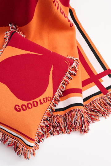 Dorothee Schumacher Wool cushion with GOOD LUCK clover motif orange verde militar mix