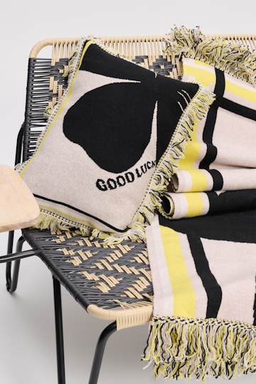Dorothee Schumacher Wool cushion with GOOD LUCK clover motif beige/black/yellow
