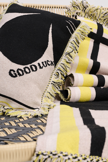 Dorothee Schumacher Wool cushion with GOOD LUCK clover motif beige/black/yellow